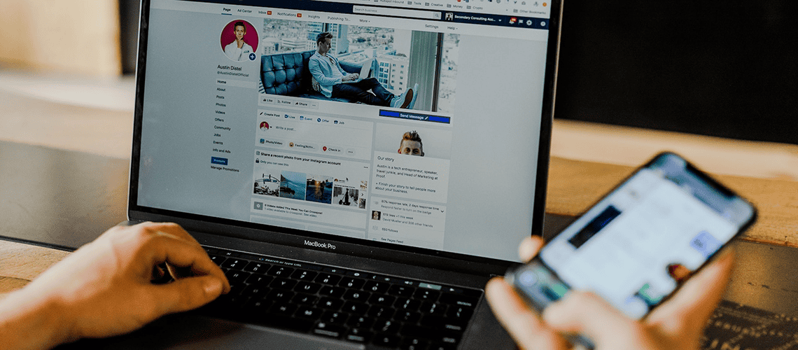 Person using laptop and phone to manage social media balance effectively.