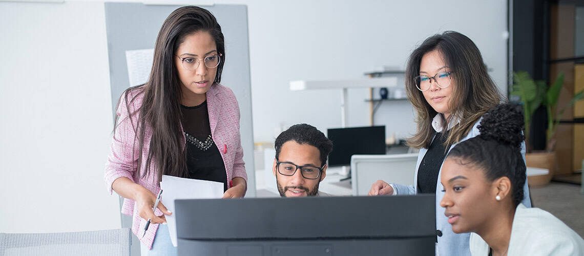 Diverse group of professionals working together on a project at the office.